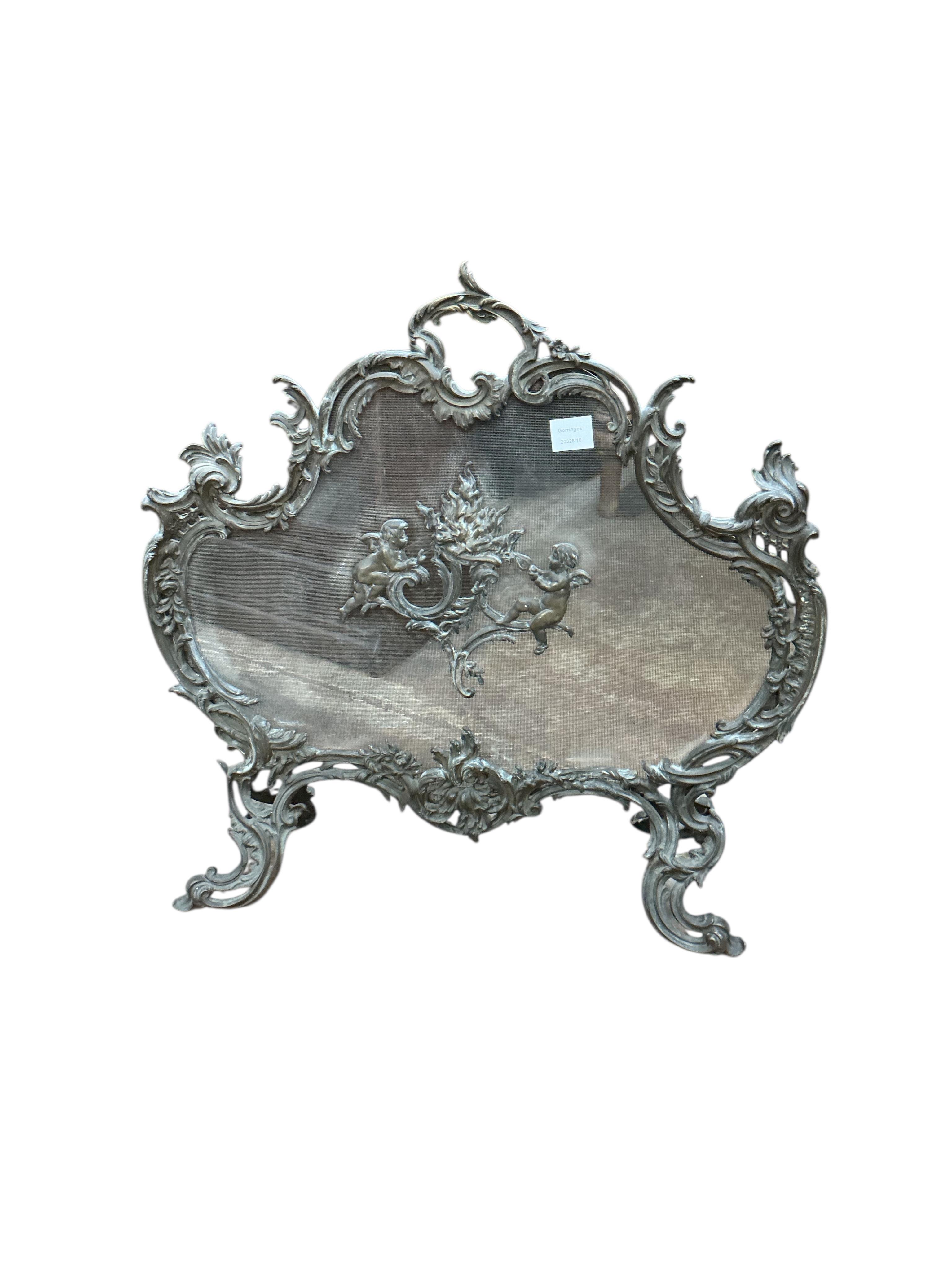 A late 19th century French rococo style cast brass mesh fire screen, width 72cm, height 70cm.